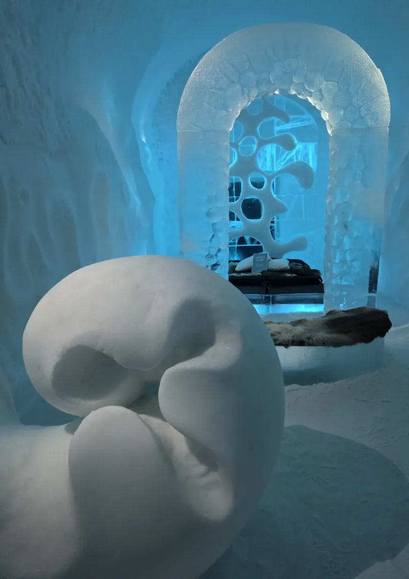 Iskonst och isskulptur i blått ljus på Icehotel
